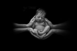 Newborn In Mum and dad's hands